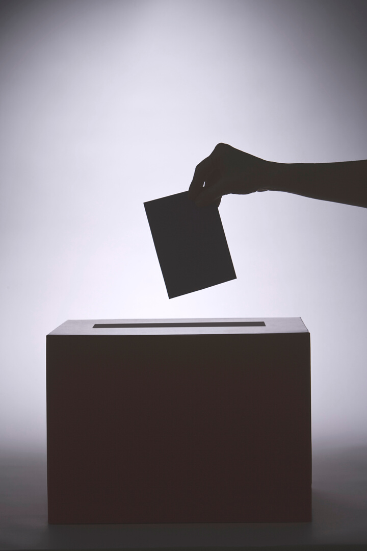 Person putting paper in box